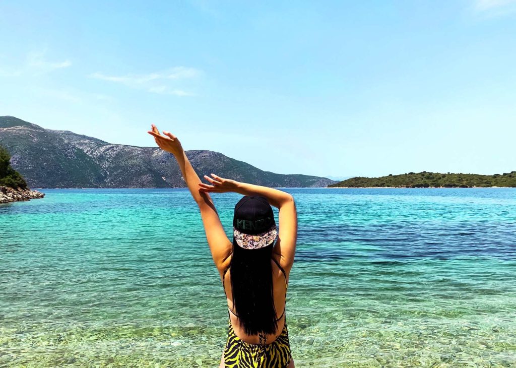 Girl on a beach in Greece while on vacation in a mykonos villa