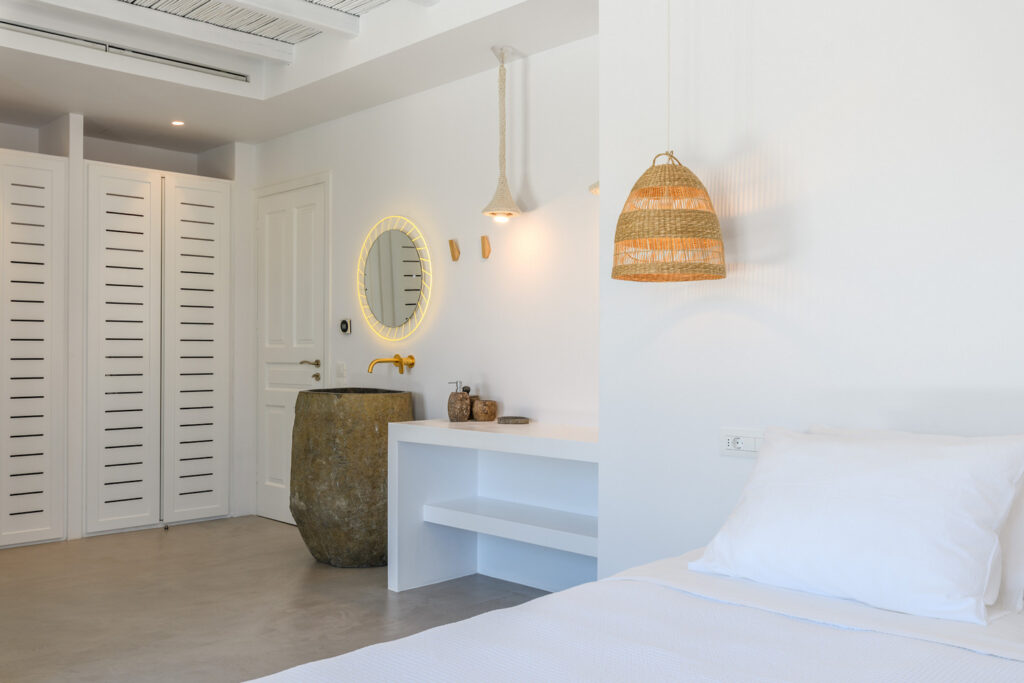 Indoor photo of a luxurious bedroom with sea view at Mykonos Top Villa, providing the ultimate vacation experience with stunning views and unparalleled comfort.
