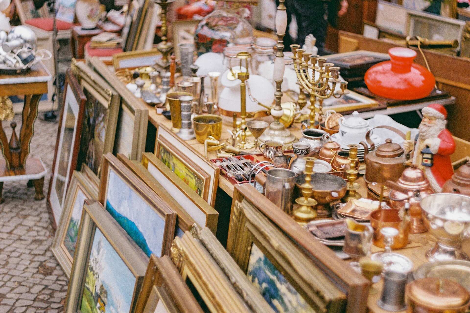 Paintings next to gold and silver trinkets