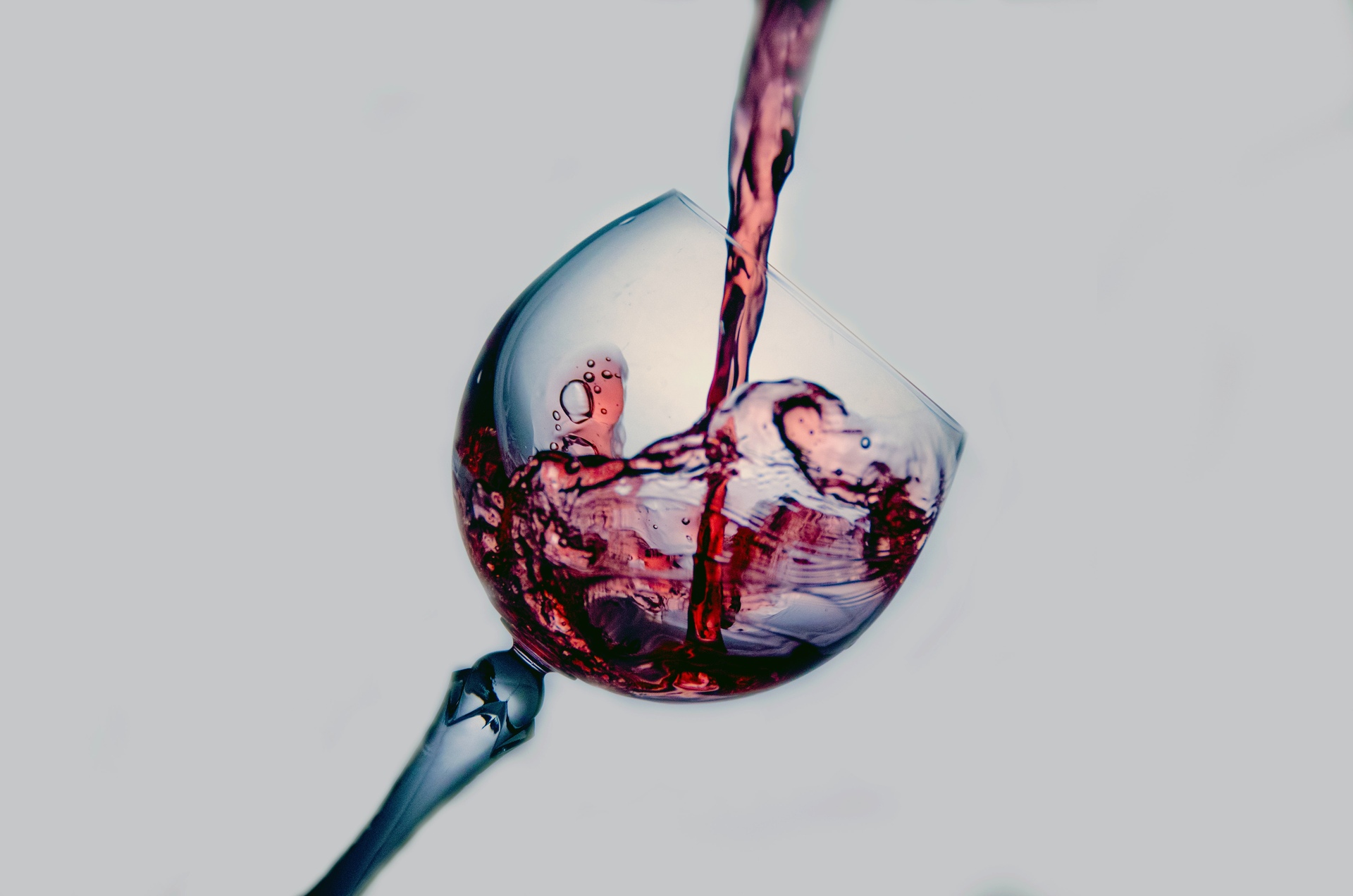 Red wine poured into a tall glass