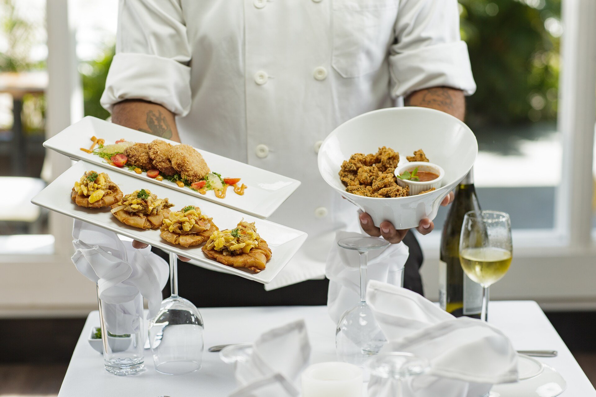 A cook holding plates of food