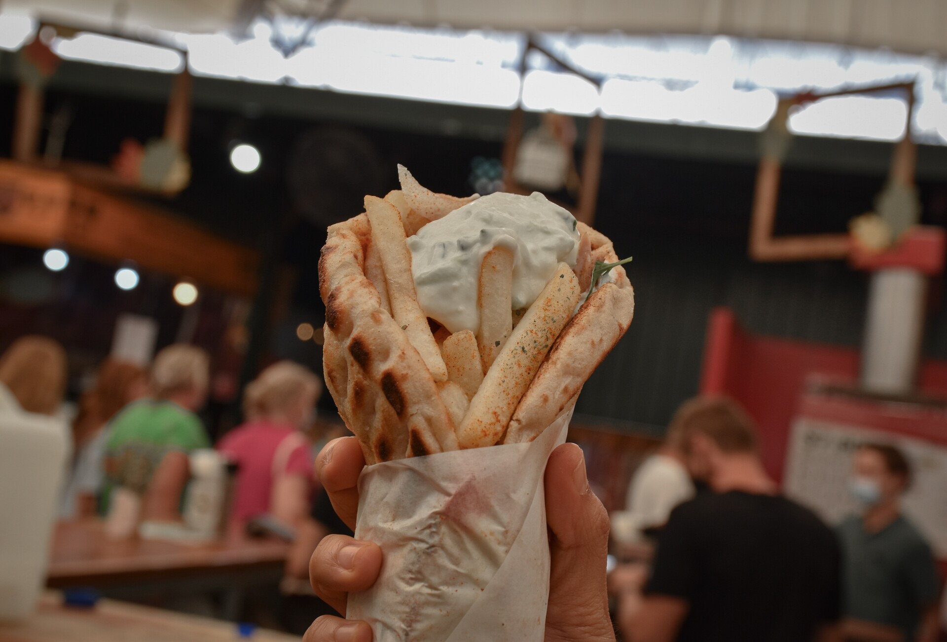 A person holding a gyro