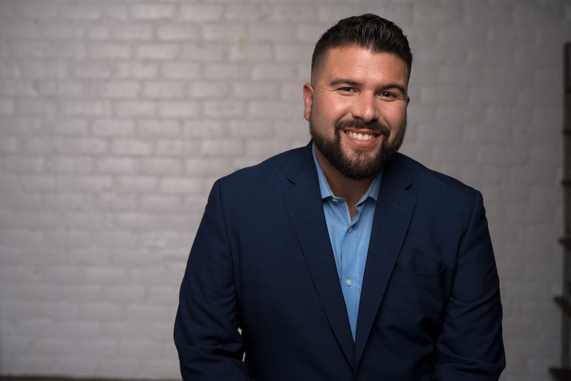 A man in a suit smiling