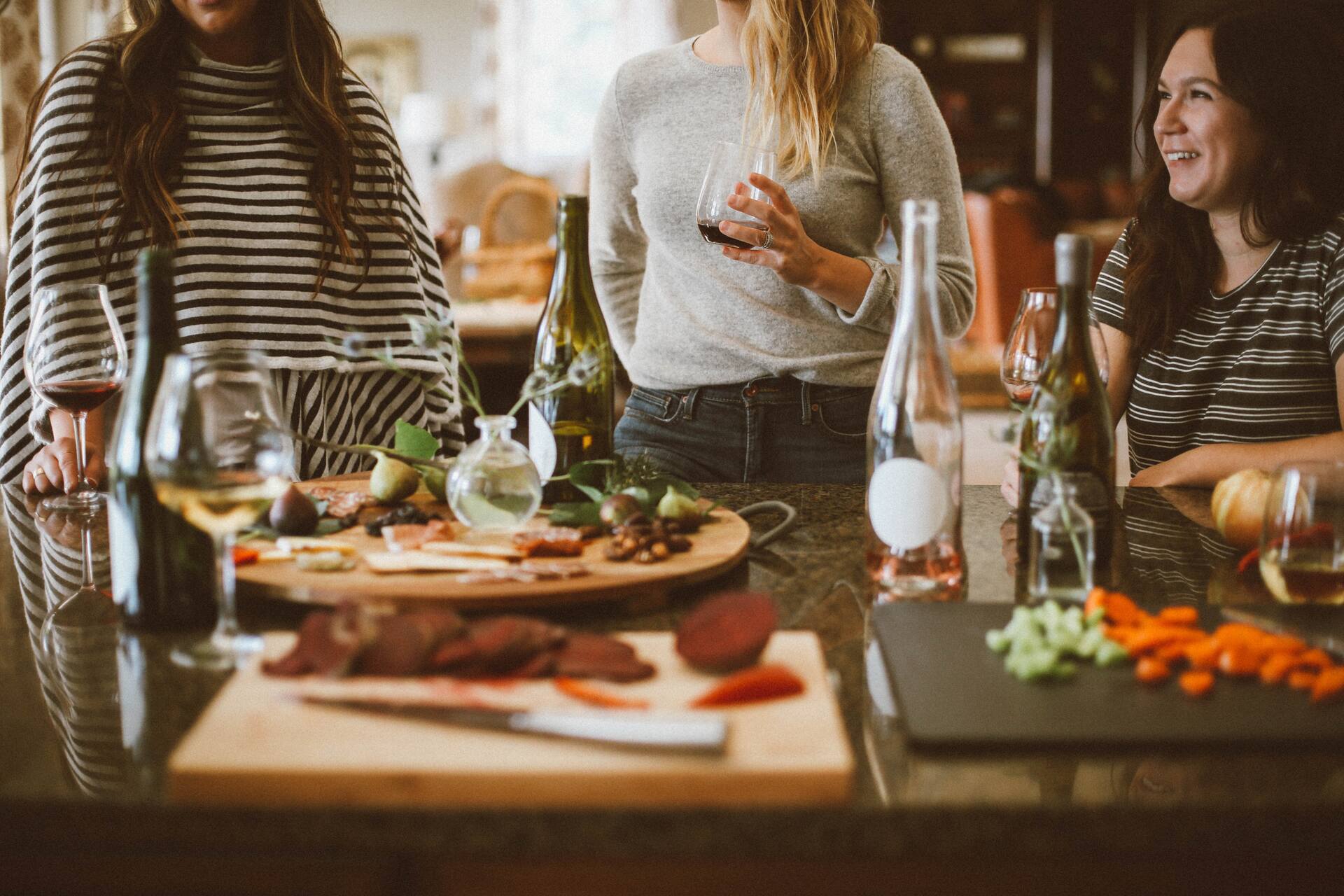 People eating and drinking wine