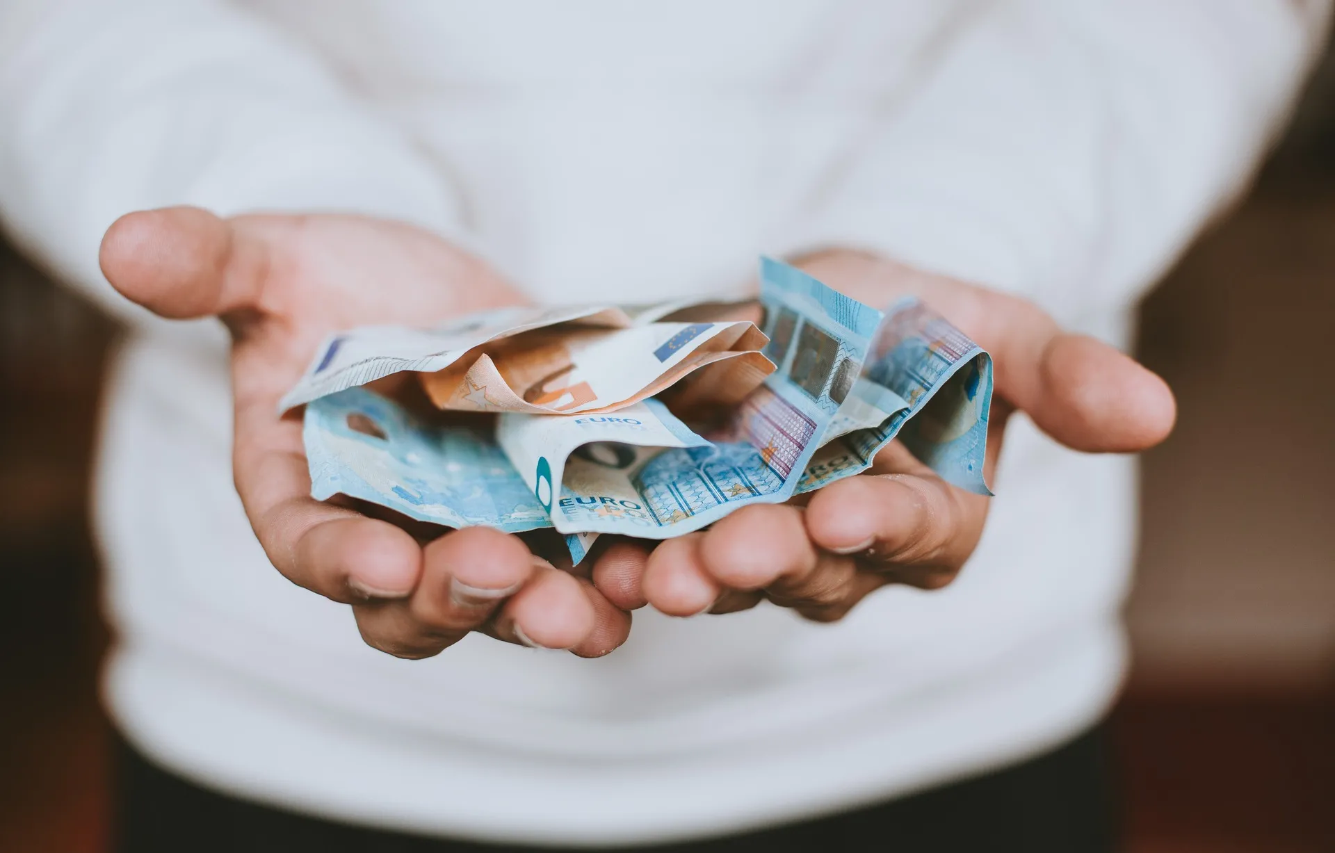 Man holding euros in his hands