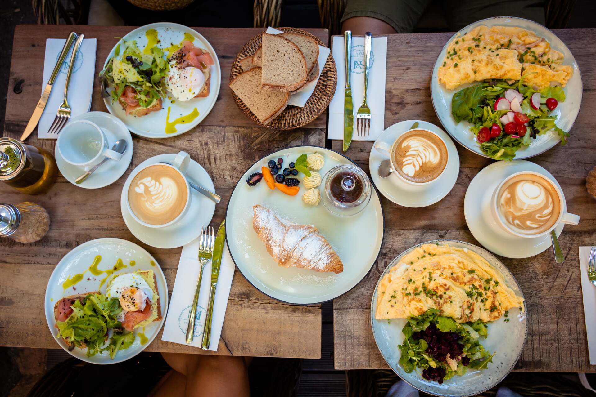Table full of breakfast options such as omelet and croissant