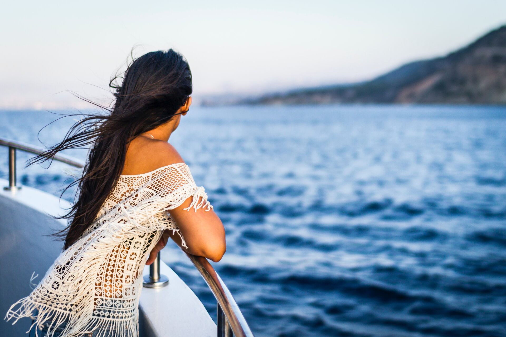Woman on a boat watching the sea