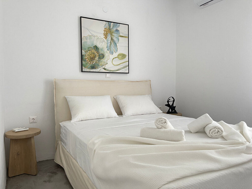 Comfortable bed in a bedroom full of light in Mykonos best villa for rent.