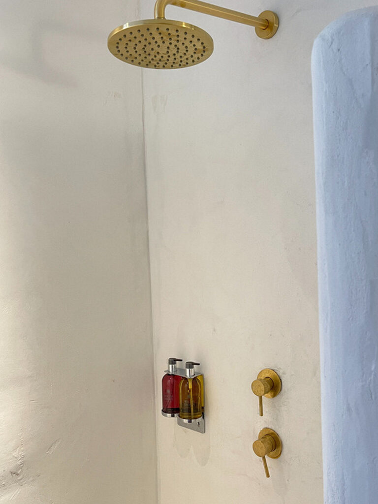 Golden shower and white walls in Mykonos splendid villa for rent.