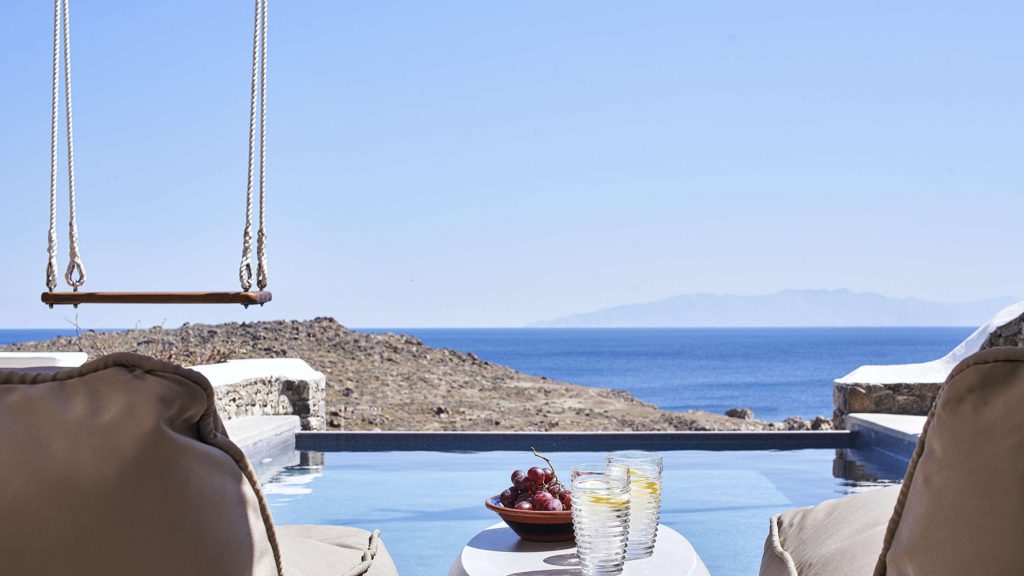 Private pool with a sea view and a swing in Mykonos private home for booking.