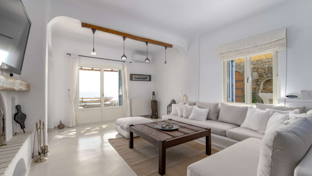 High ceiling, soft colors, and spacious living room in the best place to stay in Mykonos.