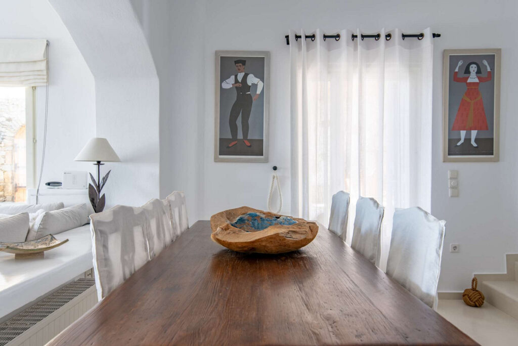 Large, wooden table in Mykonos splendid villa for booking.