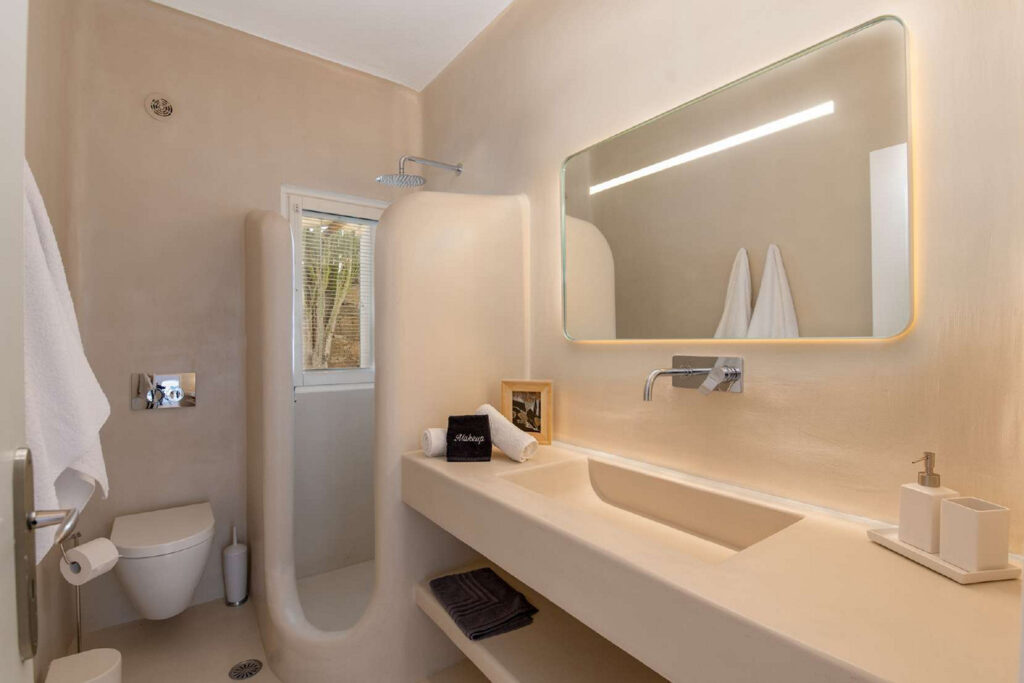Modern bathroom with all necessary amenities in Mykonos lavish villa for rent.