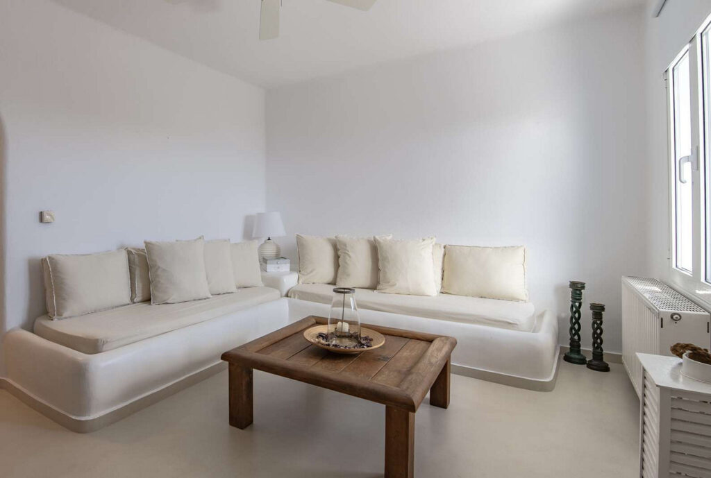 Beige sofa, and minimalist style of living room in Mykonos villa for rent, Greece.