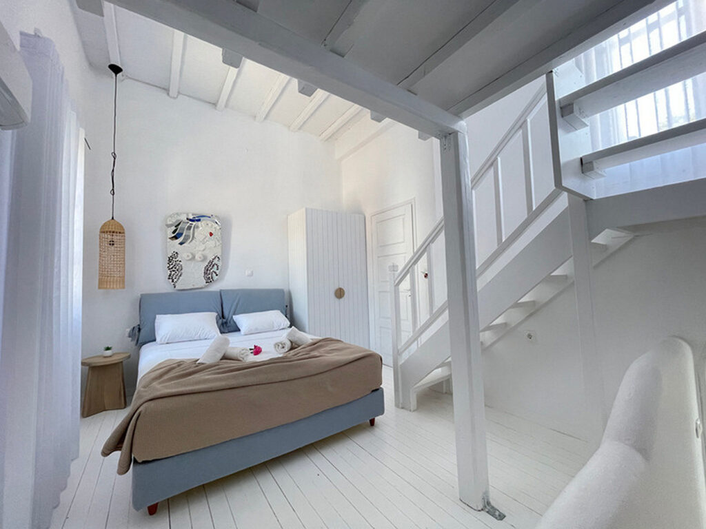 White walls and comfortable bedroom in Mykonos lavish villa for rent.