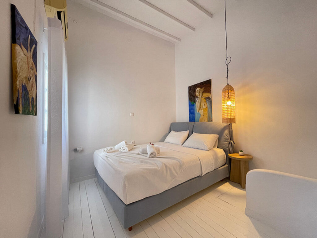 Relaxing atmosphere and gentle light of a bedroom in Mykonos private villa for rent.