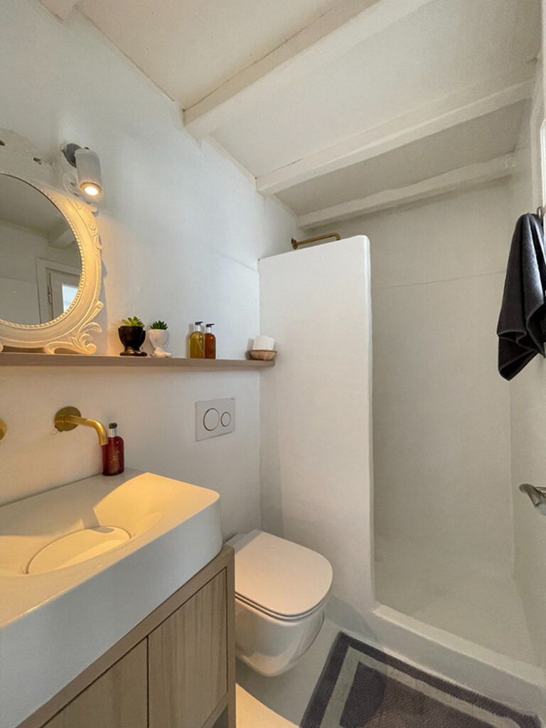White bathroom full of light and modern amenities in Mykonos' top vacation rental villa.