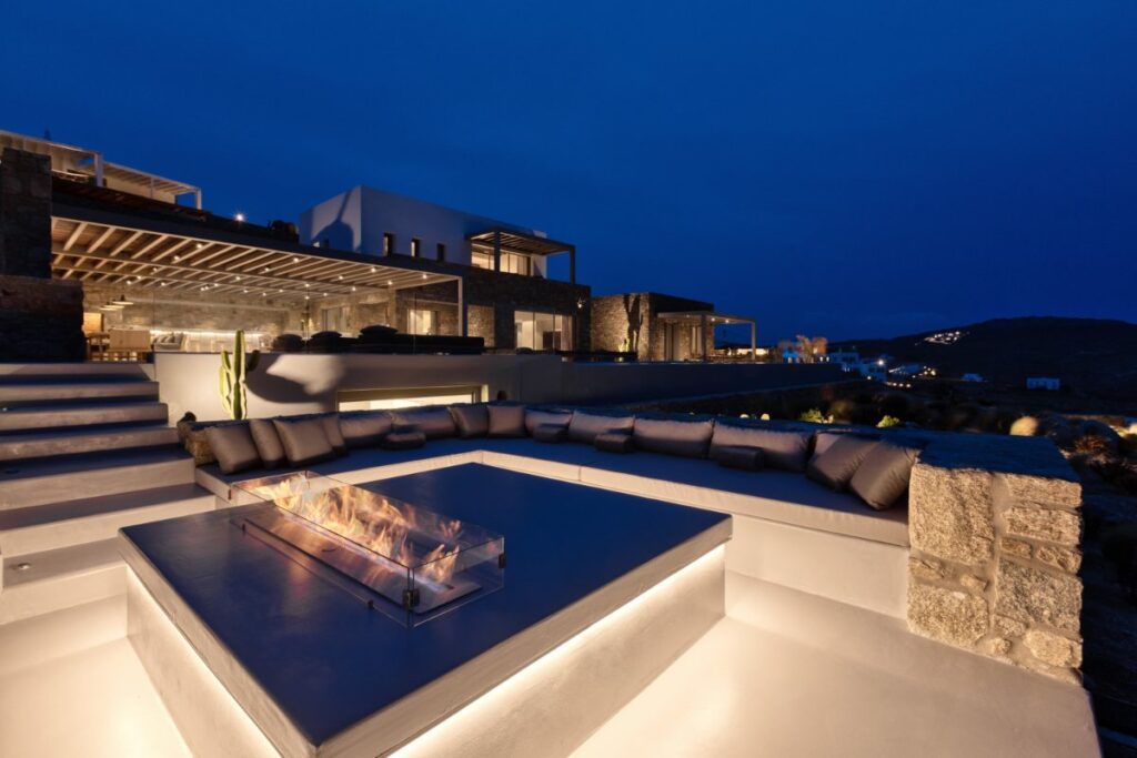 Garden bonfire and comfy sofa in an open-air area, Mykonos best rental home.