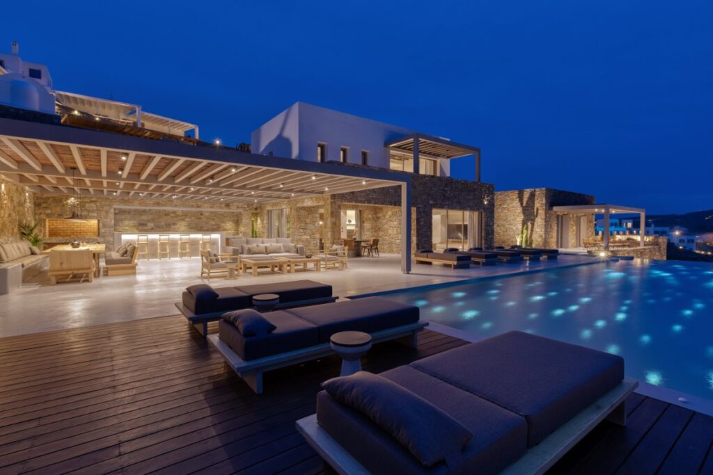 Comfortable outdoor sofa, swimming pool, and gathering area in Mykonos top rental villa.