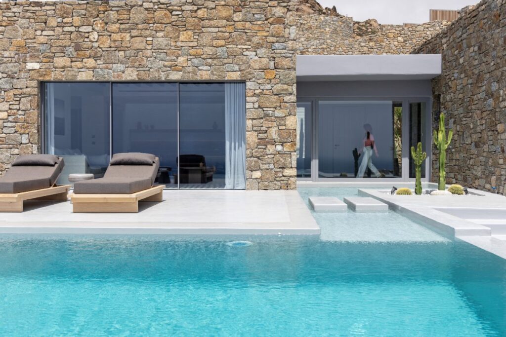 Sophisticated and elegant atmosphere next to a luxurious swimming pool in Mykonos rental villa.