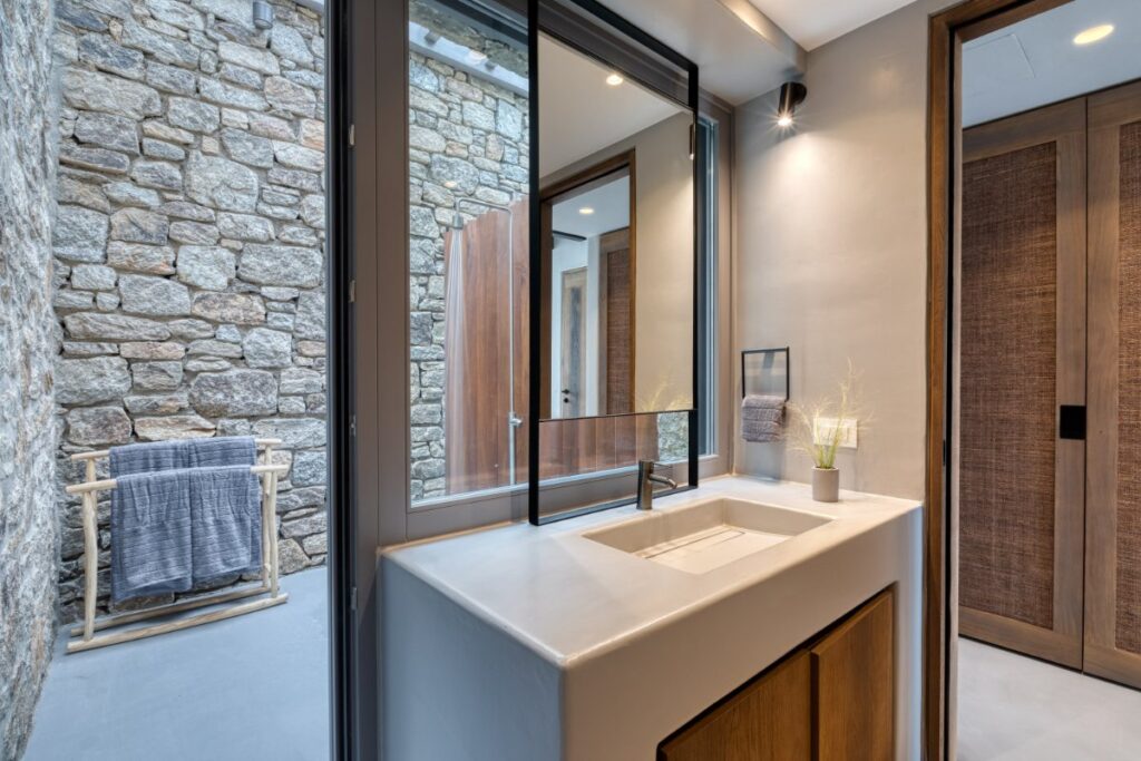 Touchless faucet and high-tech amenities in luxurious bathroom of Mykonos top rental villa.