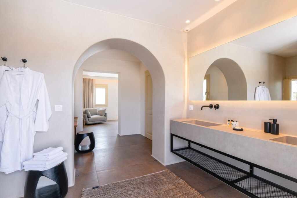 Stylish bathroom, cozy bathrobes, and bright relaxing area in Mykonos finest villa for rent.
