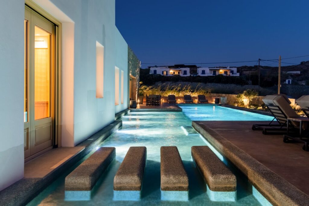 Finest Mykonos rental private home and its infinity pool, luxurious lights, and garden.