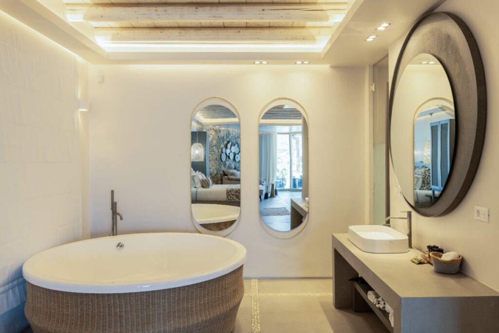 Grey modern bathroom with a large mirror in Mykonos' best vacation villa for rent.