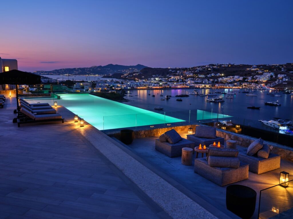 Breathtaking view of the city and sea, infinity pool, and comfy sofa in Mykonos best rental place.