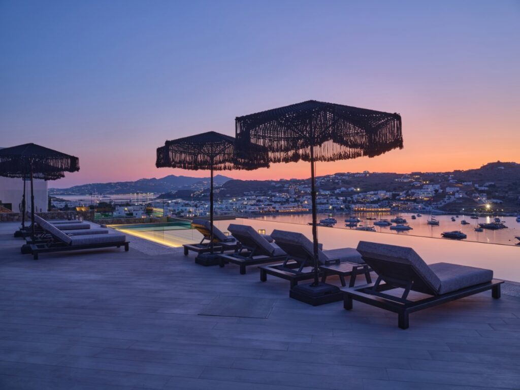 Look over astonishing sunset and city by the night in Mykonos best rental villa.