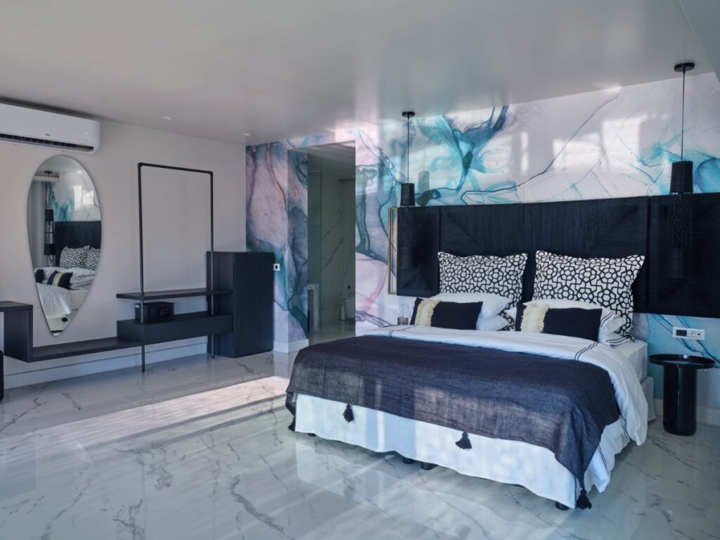 Sumptuous bedroom with lavish touches, state-of-the-art amenities, and a deluxe bed in Mykonos rental home.