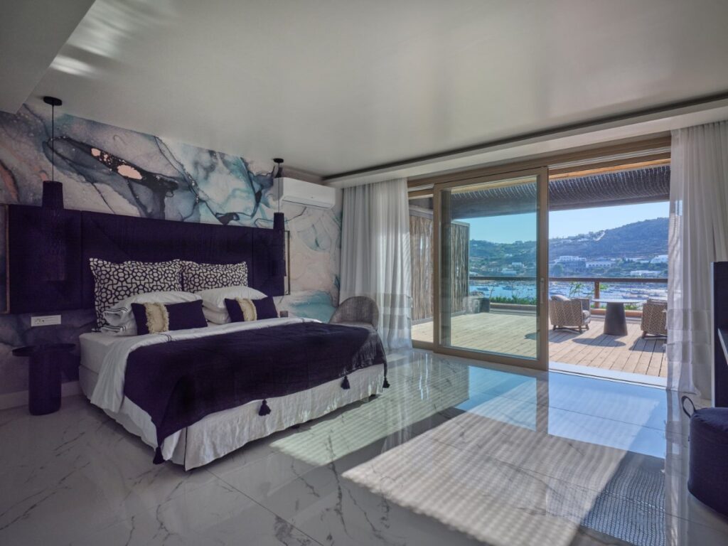 Mykonos rental villa bedroom offers the perfect blend of luxury and enjoyment, with ultra-modern amenities and a dreamy sea view.