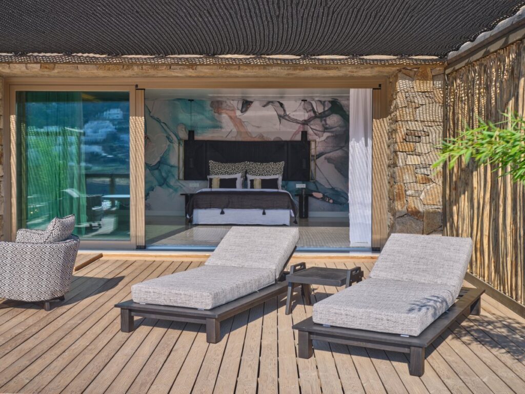 Soft cushions and sun beds on a terrace in Mykonos private rental home.