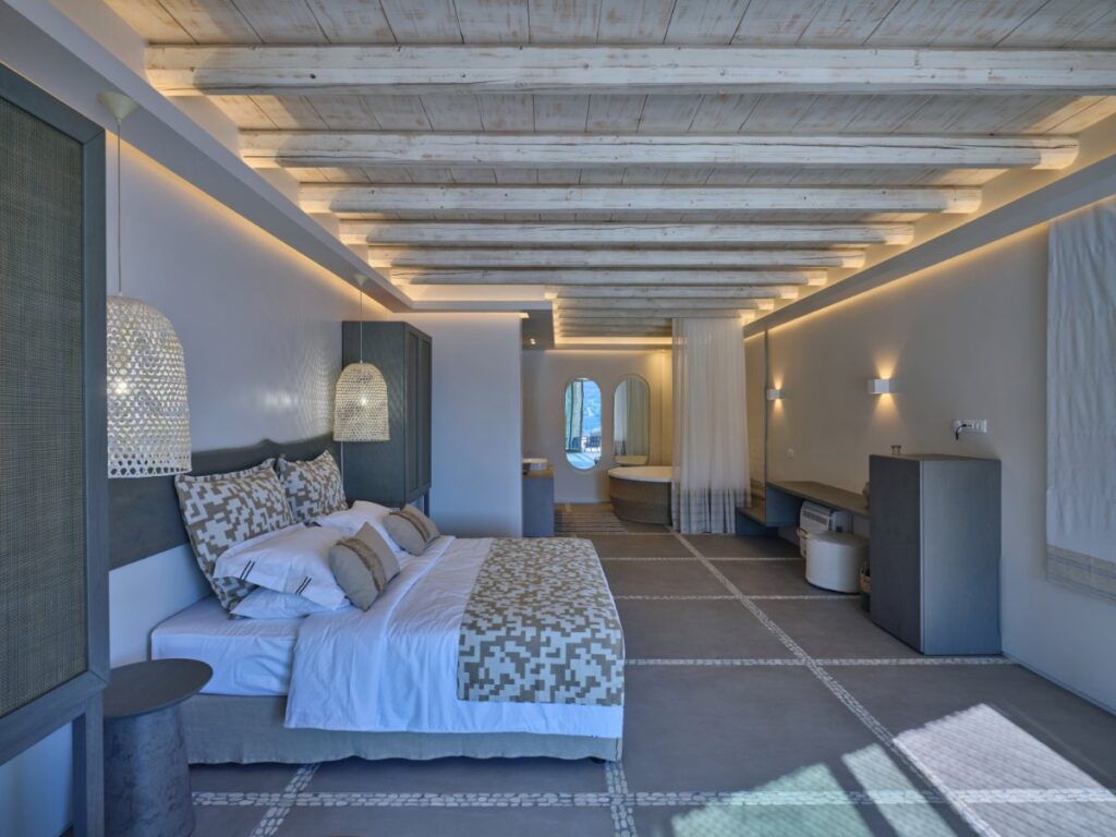 Gentle ambient lighting and cozy atmosphere in Mykonos rental luxurious villa's bedroom.