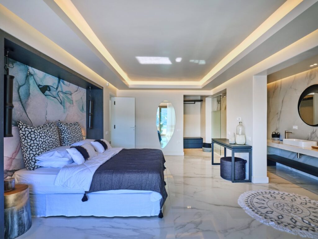 Soothing walls and décor of deluxe bedroom in Mykonos finest villa for rent.