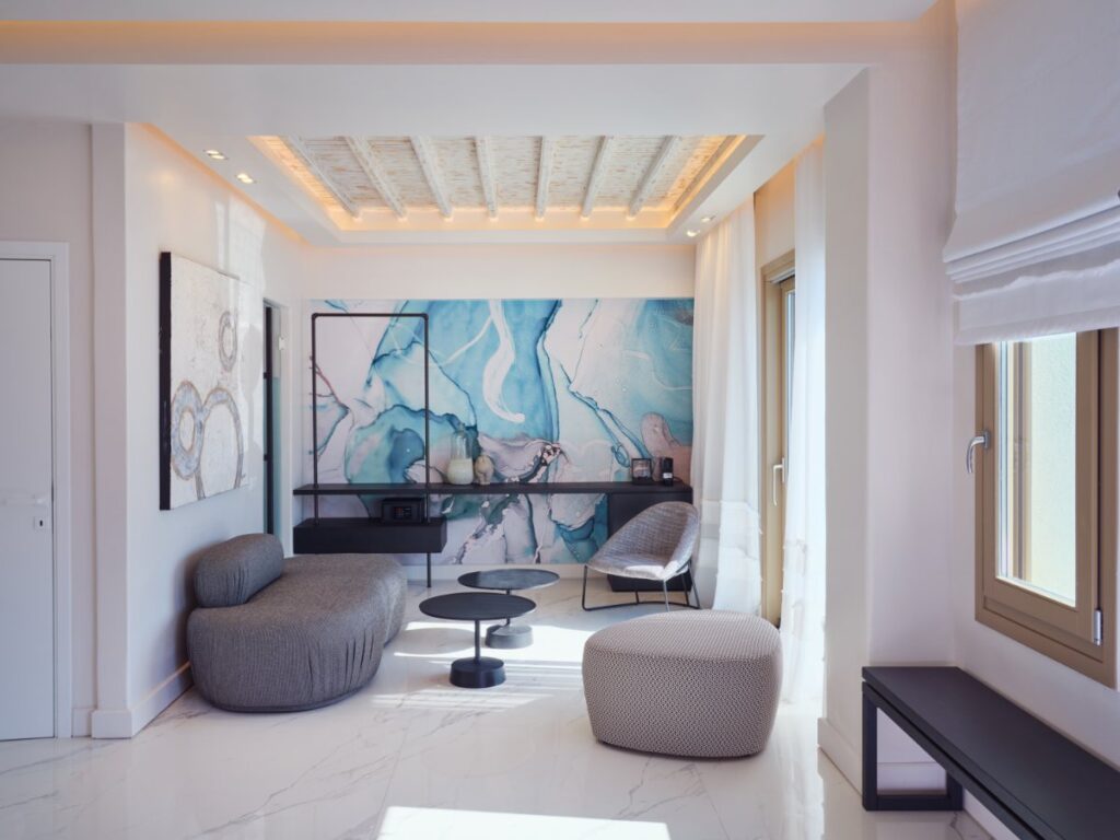 Experience the height of luxury within the best Mykonos villa for rent, with its cozy armchairs and stunning artwork.