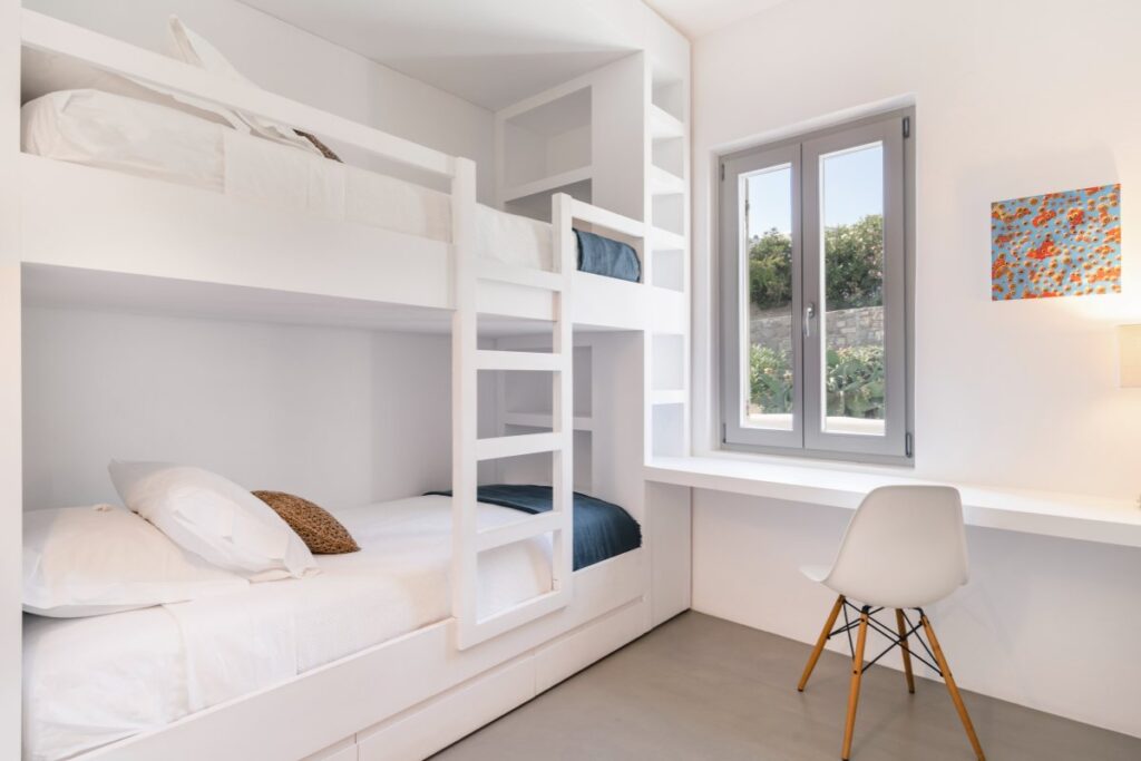 Sophisticated and comfortable bedroom with bunk beds in the best rental villa in Mykonos, Greece.