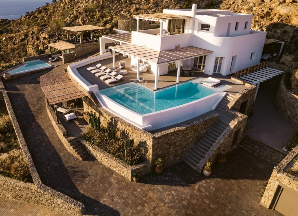 Mykonos holidays three-floor villa ready to rent. Spacious and luxurious infinity pool for chilling out and enjoying.