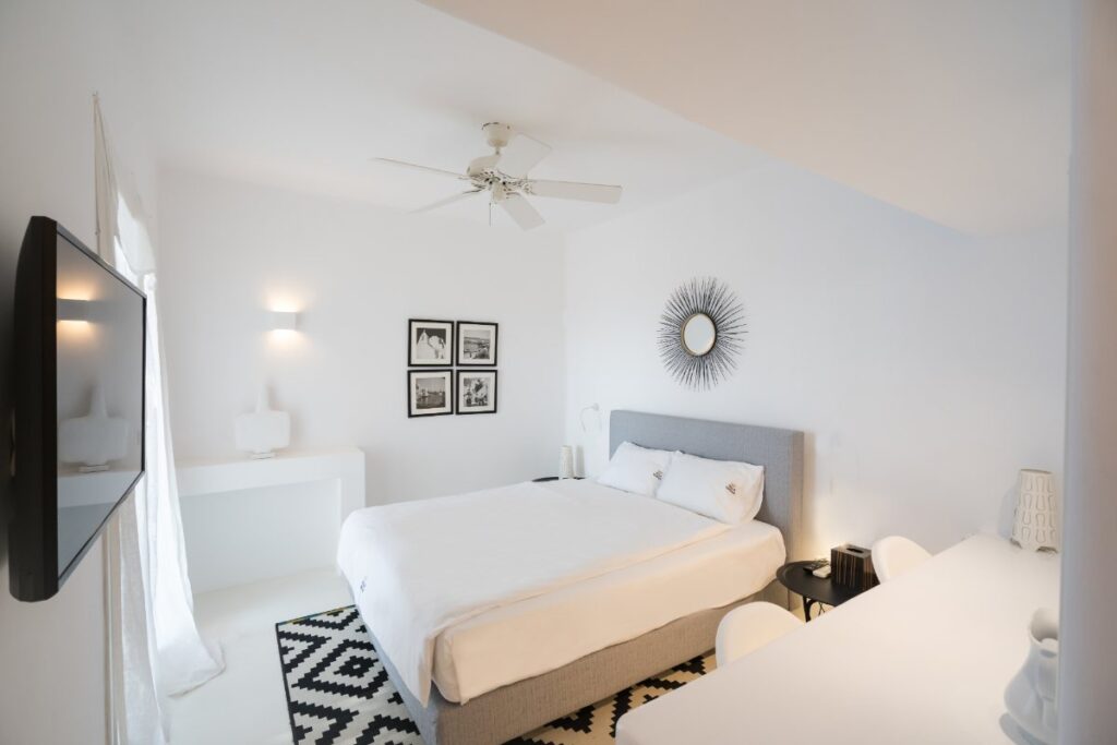Black and white sophisticated, cozy bedroom with a gentle ambient in a private vacation home for rent, Mykonos, Greece.
