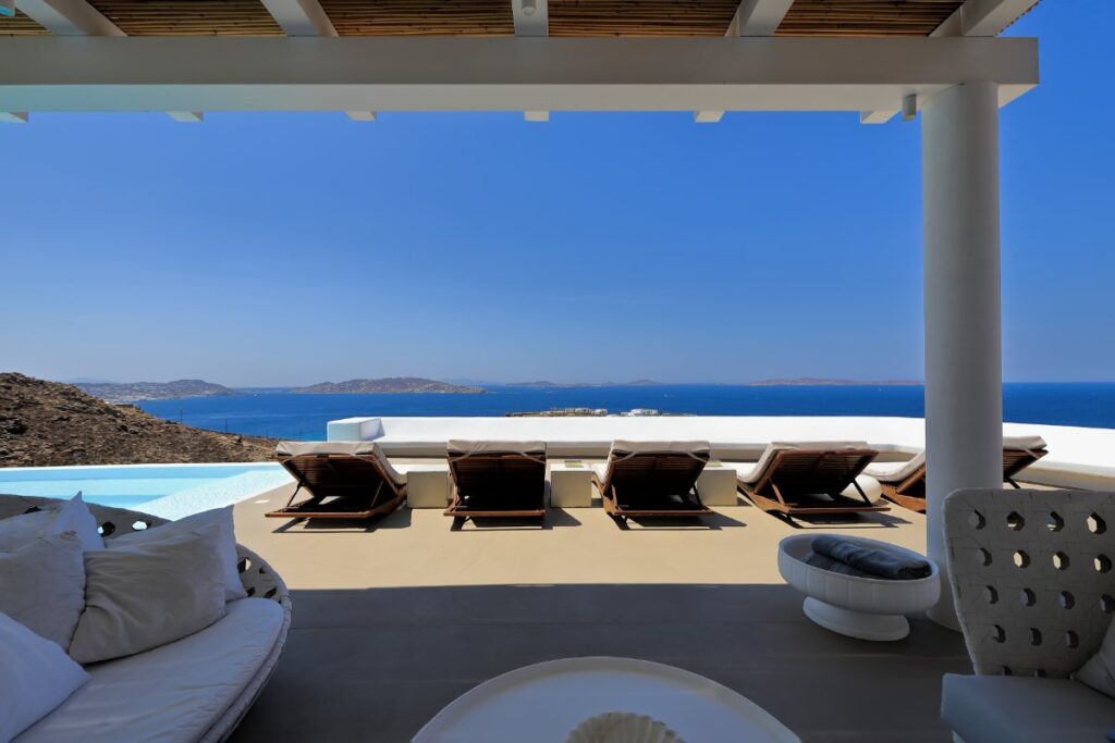 Zen oasis next to the private infinity pool, with comfy sun beds and an astonishing view of the Aegean sea in the best Mykonos rental villa