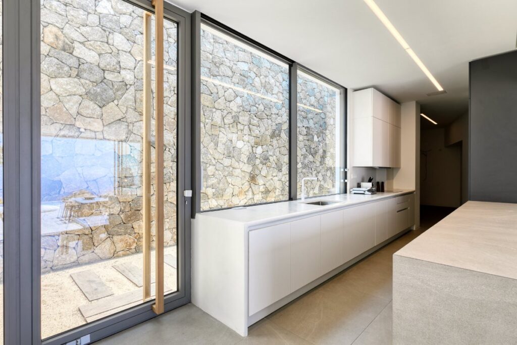 Bright and elegant kitchen with large windows in Mykonos' top rental villa.