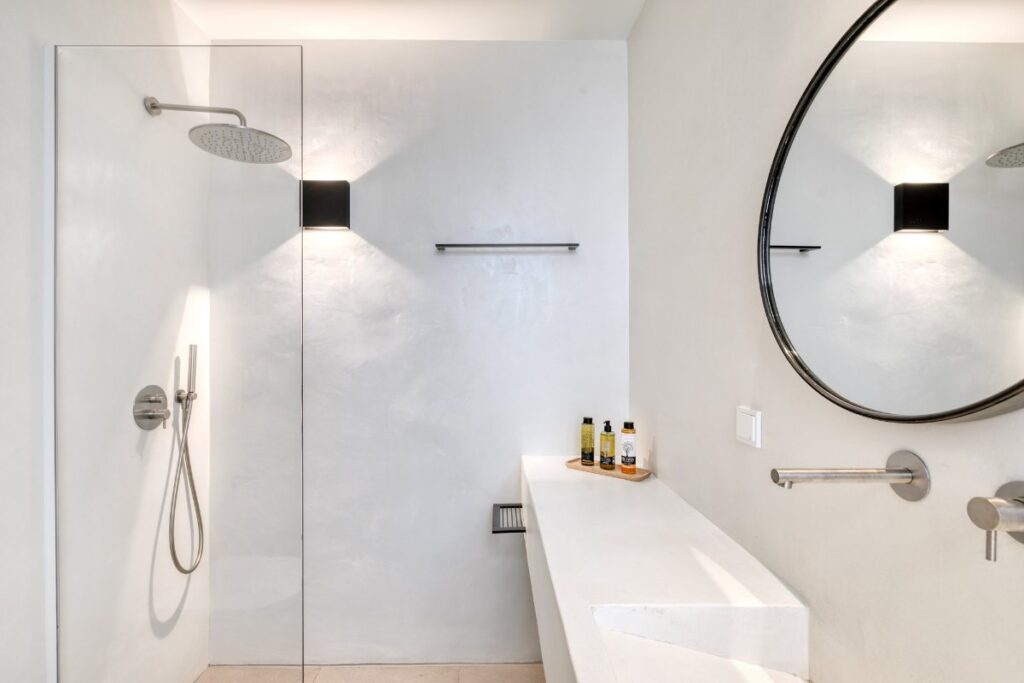 High-quality bathroom with a spacious shower and a mirror in an exceptional Mykonos villa for rent.
