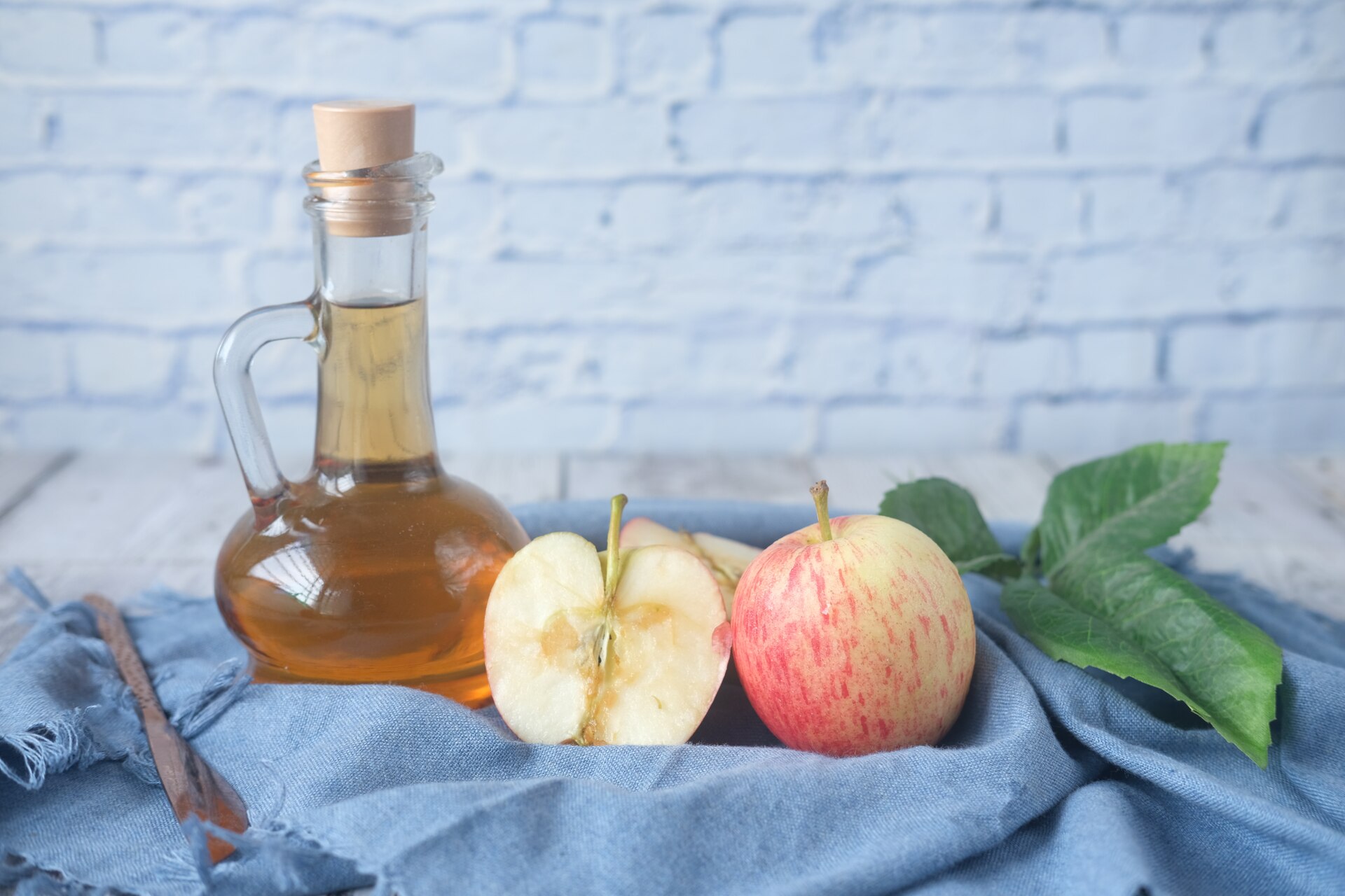 Bottle of vinegar and an apple 