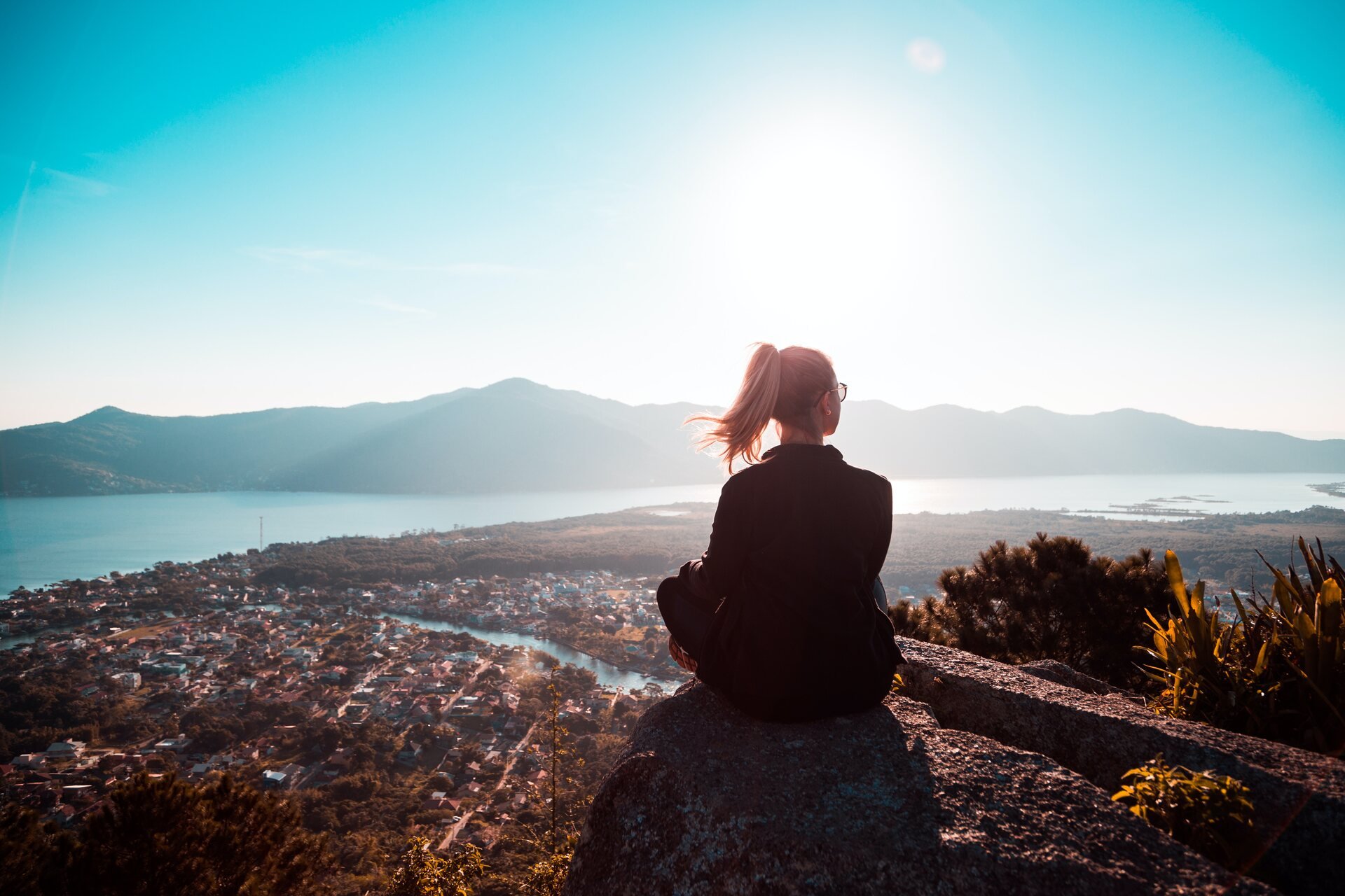 Girl sitting at the top of a hill 