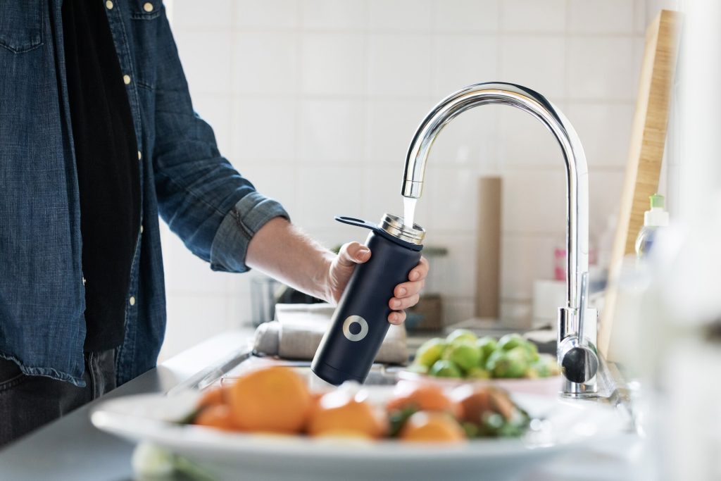 Man pouring water from a tap