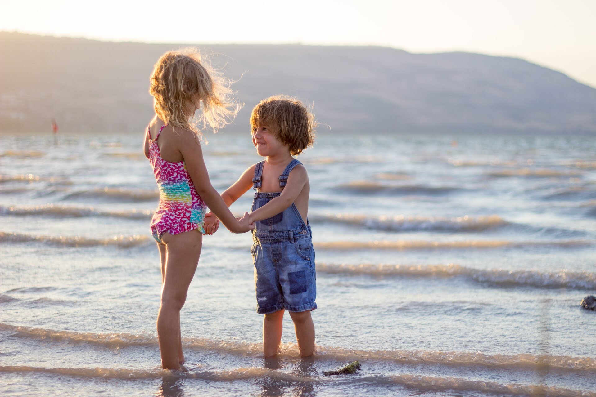 Two girls standing on a beach