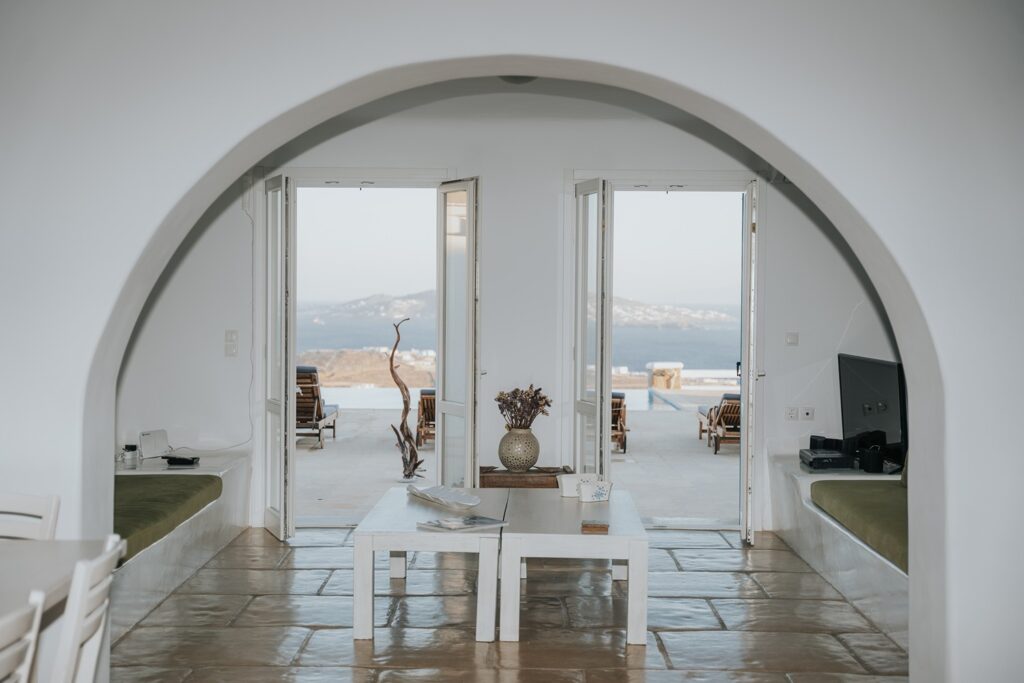 Spacious living room with access to a terrace and a beautiful sea view, Mykonos rental villa.