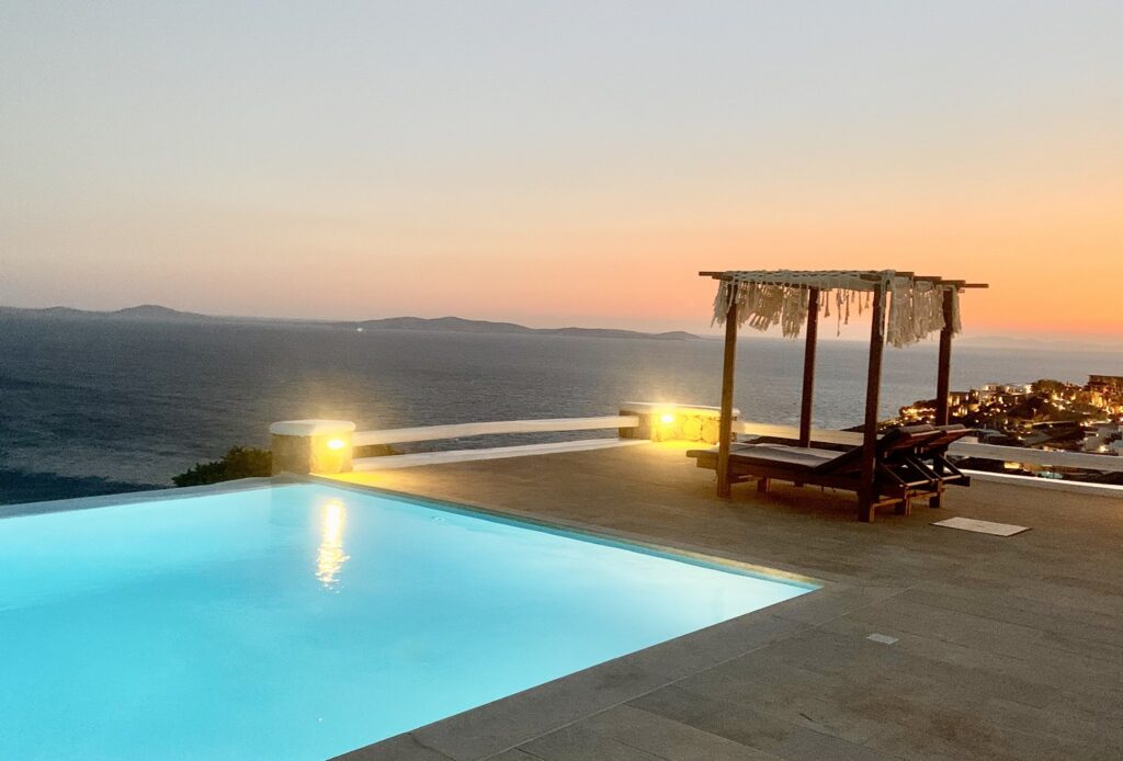 Sunbeds, a private pool, and a perfect view of the Aegean Sea, the best holiday villa, Mykonos.