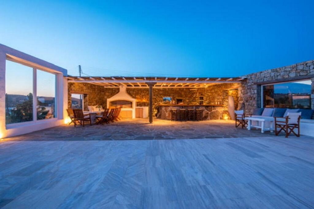 Soft lights and cozy furniture outside of Mykonos best villa for rent.