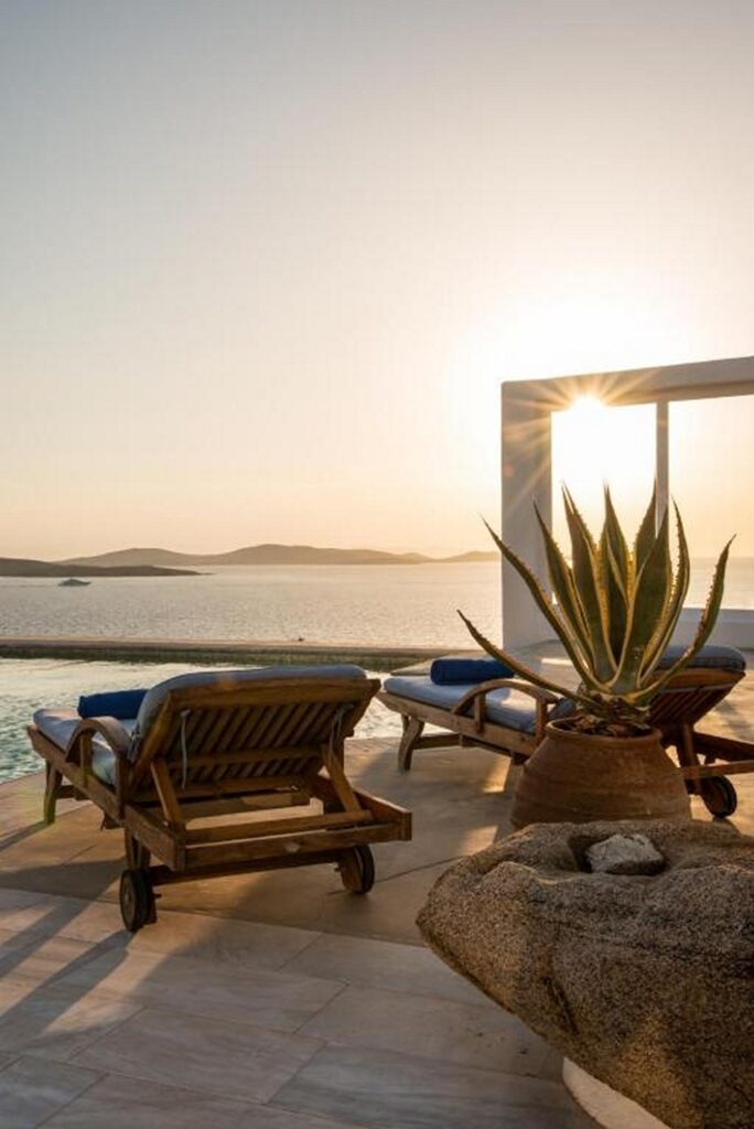 Sunbeds, sea view, and sunset from the best Mykonos villa for booking.